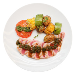 Grilled tuna and vegetables with salsa, isolated on white