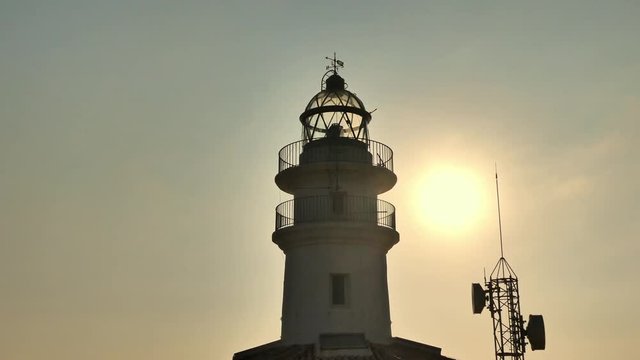 Mediterranean lighthouse of Cullera in the morning with golden light