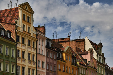 Fototapeta na wymiar Colorful historic buildings with dramatic sky in Wroclaw, Poland.