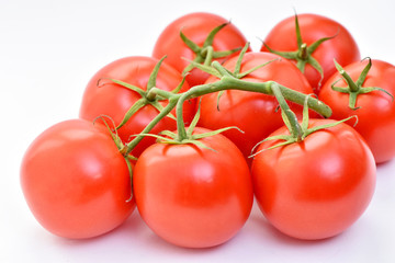 Isolated tomatoes on a white background.
