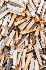 chaotically arranged in a pile of fresh chopped firewood, abstract background