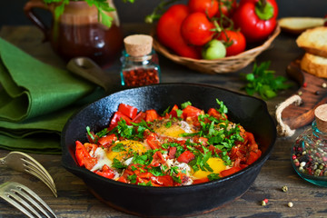 Shakshuka is a traditional breakfast of Israeli cuisine. Eggs fried in tomato sauce with pepper, onions and spices.