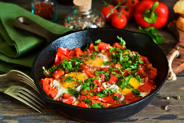 Shakshuka is a traditional breakfast of Israeli cuisine. Eggs fried in tomato sauce with pepper, onions and spices.