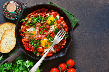 Shakshuka is a traditional breakfast of Israeli cuisine. Eggs fried in tomato sauce with pepper,...