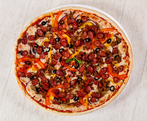 Pizza with sausages and minced meat