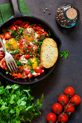 Shakshuka is a traditional breakfast of Israeli cuisine. Eggs fried in tomato sauce with pepper, onions and spices.
