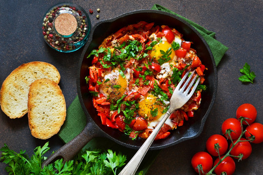 Shakshuka is a traditional breakfast of Israeli cuisine. Eggs fried in tomato sauce with pepper, onions and spices.