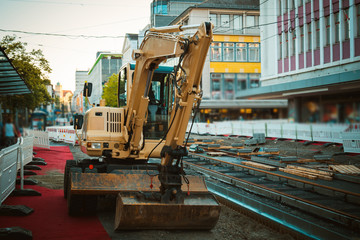 Excavator in the background of construction in the city