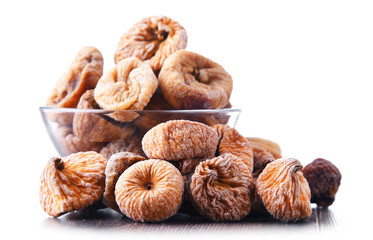 Composition with bowl of dried figs isolated on white
