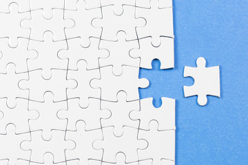 Blue background made from white puzzle pieces and place for your content 