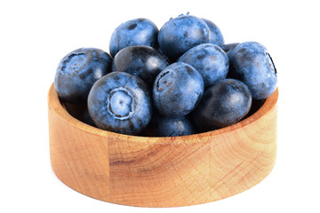 fresh ripe blueberry in wooden bowl isolated on white background