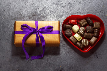 Fototapeta na wymiar various chocolate in heart shape box with present for valentine's day