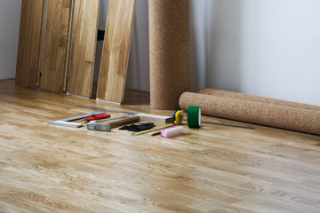 Room interior in the course of laying of a floor from parquet sheets of the oak massif and the tool for laying of a floor