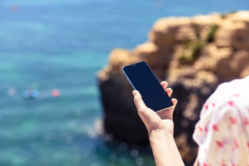 Man holding mobile phone nature blue sky outdoors. Closeup on handsome person use wireless digital smartphone device, modern design, communication technology lifestyle.