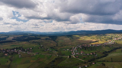 Fototapeta na wymiar small village and cloudy day from air shoot 