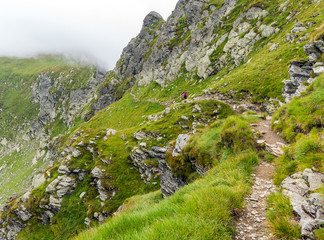 Woman hiking into rocky mountains