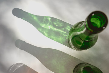 Beer bottle reflecting on a white table