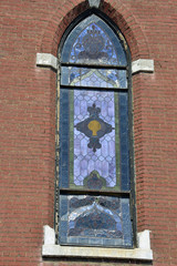 Old abandoned church View of damaged stained glass windows