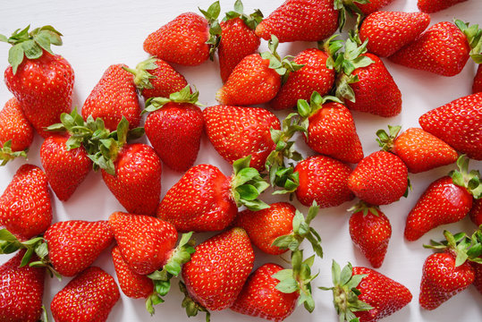 Fresh strawberry. Strawberries on white concrete background. Harvest of organic local strawberries