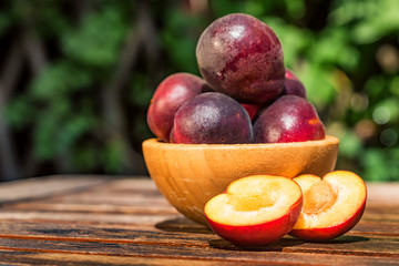 Pluot, mix of plum and apricot in wooden bowl