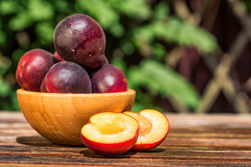 Pluot, mix of plum and apricot in wooden bowl