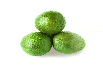 Whole green avocado isolated on white background
