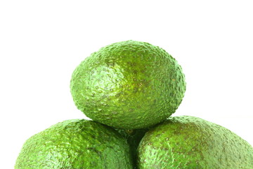 Whole green avocado isolated on white background
