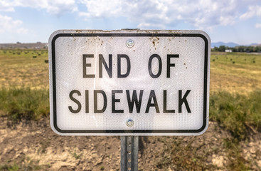 End of sidewalk sign straight on