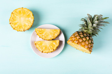 Slice pineapple on green background, top view, tropical fruit