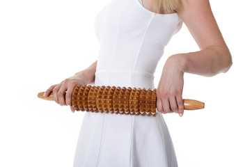 Woman with anticellulite rolling pin in hands