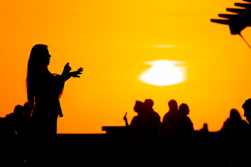 Fototapeta na wymiar Silhouette of a woman having fun at sunset in the Miraflores district (Lima, Peru)