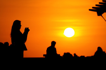 Silhouette of a woman having fun at sunset in the Miraflores district (Lima, Peru)