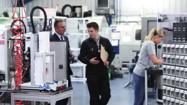 Business Owner In Factory Shaking Hands With Engineer