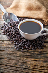 hot coffee cup on coffee beans