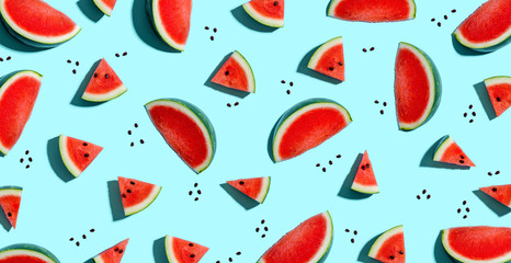 Sliced watermelons arranged on a blue background