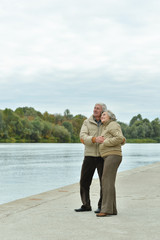 Fototapeta premium Happy senior couple near water