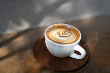 Cup of cappuccino, the sun and shadows. Soft focus