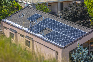 Solar panels sitting on rooftop on sunny day