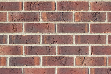Traditional running bond pattern brown brick wall background with rust color striations