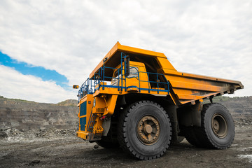 Large quarry dump truck. Loading the rock in dumper. Loading coal into body truck. Production useful minerals. Mining truck mining machinery, to transport coal from open-pit as the coal production.