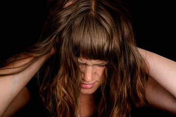 Depressed woman with hands in her hair