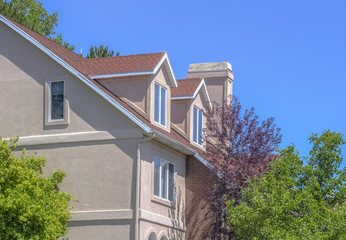 Suburban home with three leves and trees