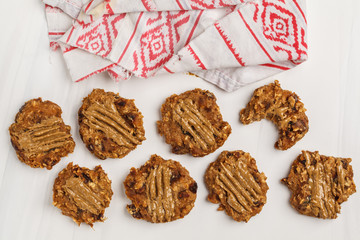 Vegan oatmeal cookies with peanut butter on white background, top view. Healthy vegan food concept.