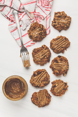 Vegan oatmeal cookies with peanut butter on white background, top view.