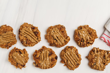 Vegan oatmeal cookies with peanut butter on white background, top view. Healthy vegan food concept.