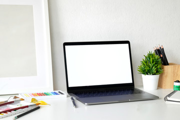 Artist creative workspace and blank screen laptop.