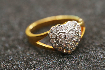 Diamond heart symbol on gold ring