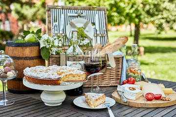 Assorted desserts and cheeses on wooden table