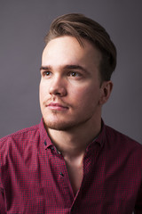 Obraz premium Studio portrait of young man on a dark background
