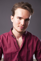 Fototapeta premium Studio portrait of young man on a dark background